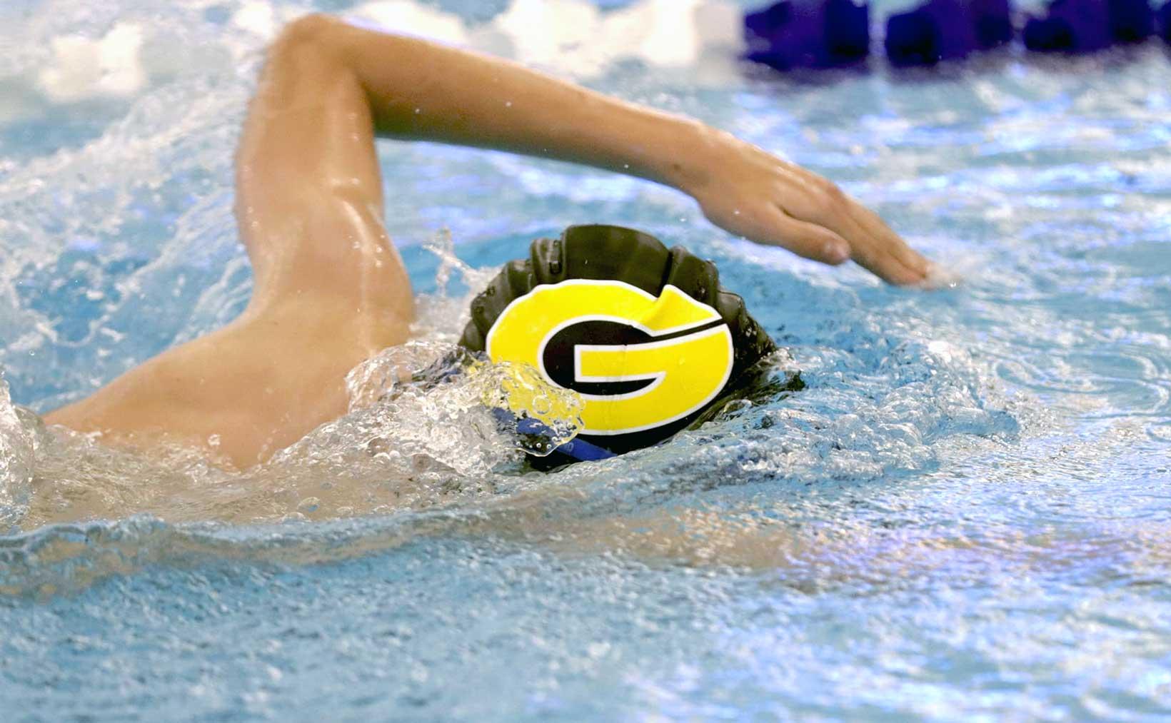 A close up of an HS swimmer doing laps