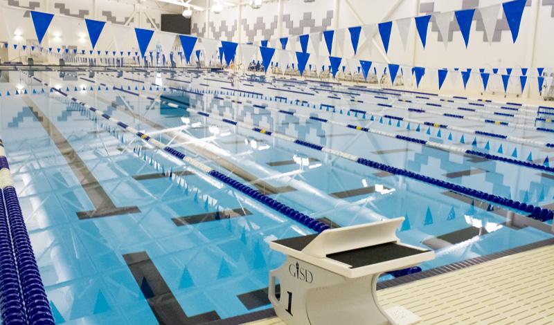 A wideshot of the natatorium's lap pool and a scoreboard